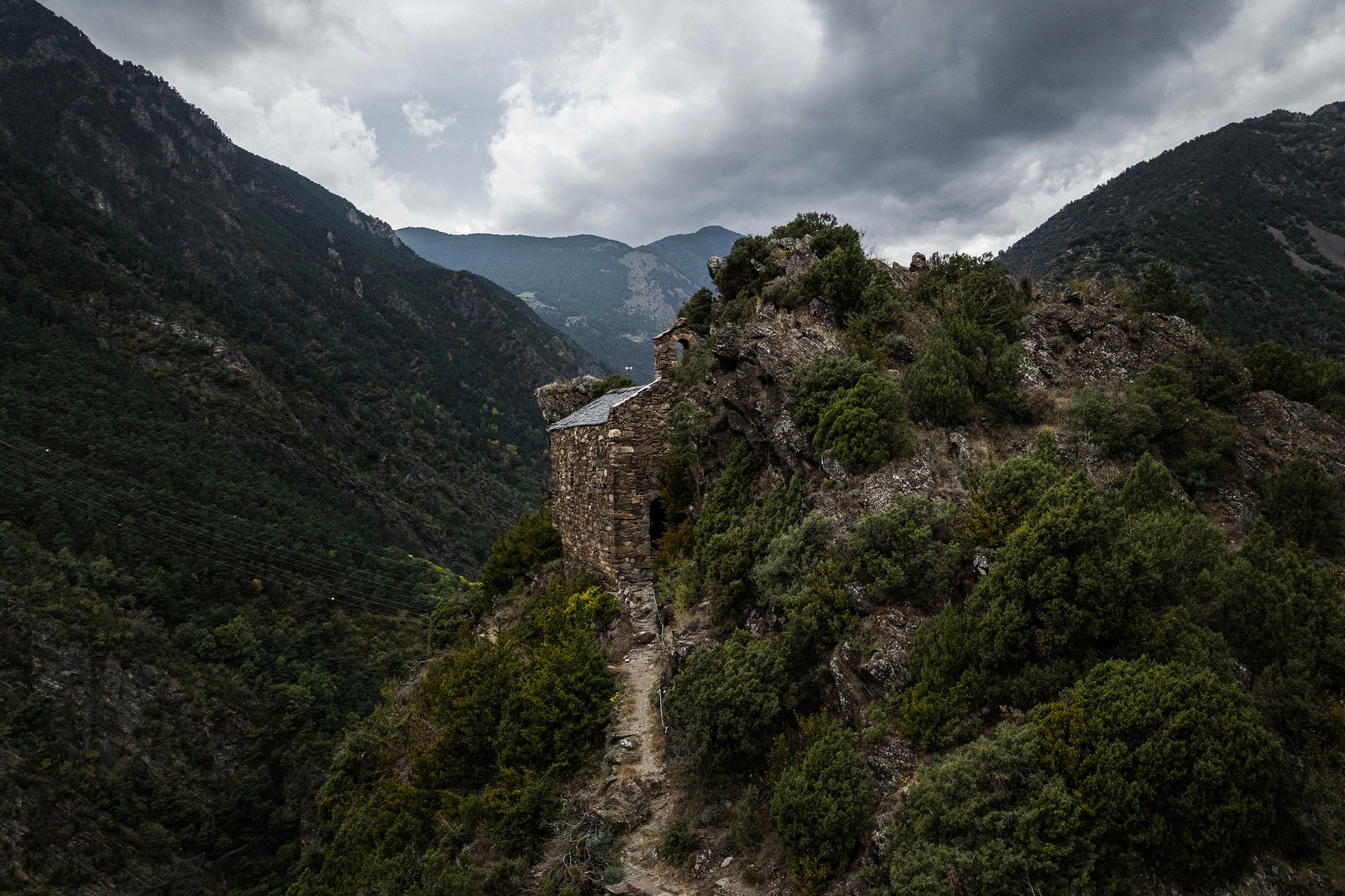 Las iglesias más pequeñas carecen de torre y lucen en su lugar una sencilla espadaña para su campana. Sant Martí de Nagol (siglo XI) representa este románico más temprano y humilde: una arquitectura de subsistencia fundida con la roca, ubicada en lugares elevados para tener una visión estratégica del valle.